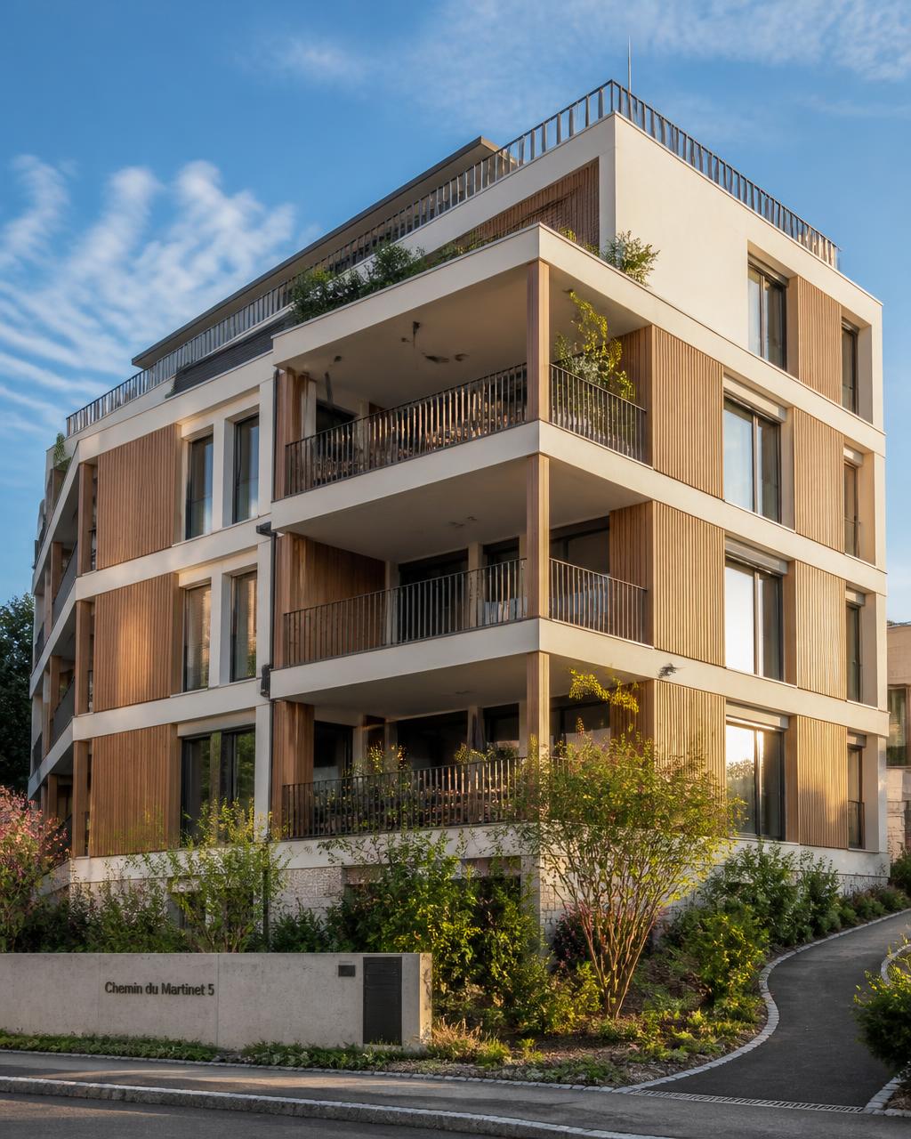 Immeuble résidentiel contemporain en Suisse romande avec balcons et façade bois